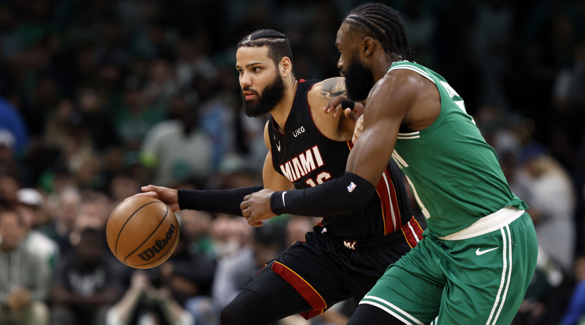 Miami Heat forward Caleb Martin controls the ball against Boston Celtics guard Jaylen Brown.